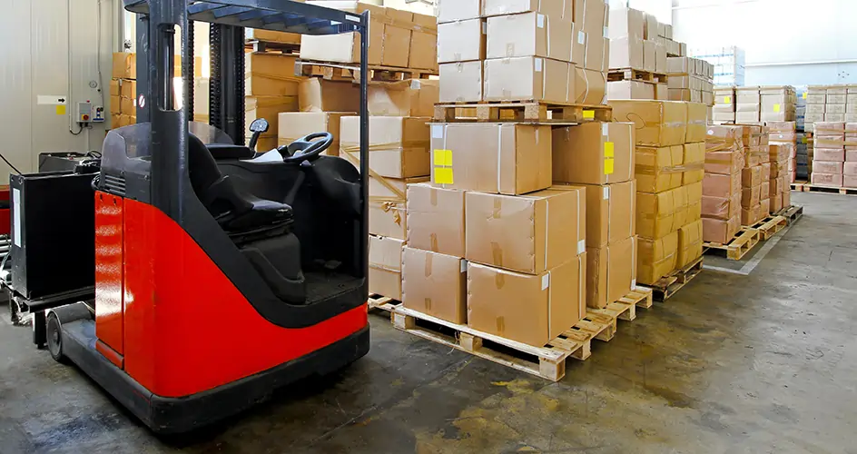 Forklift next to boxes in warehouse